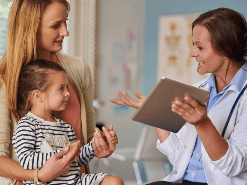 Paediatrician with mother and little girl
